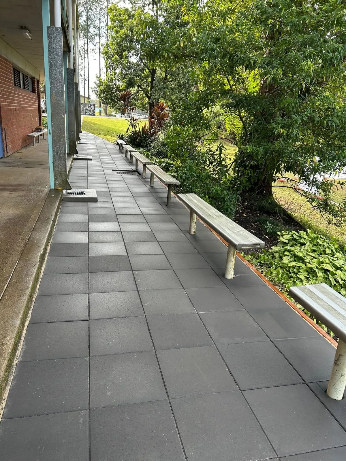 New paved walkway with steel bench seating through the Bellingen High School grounds