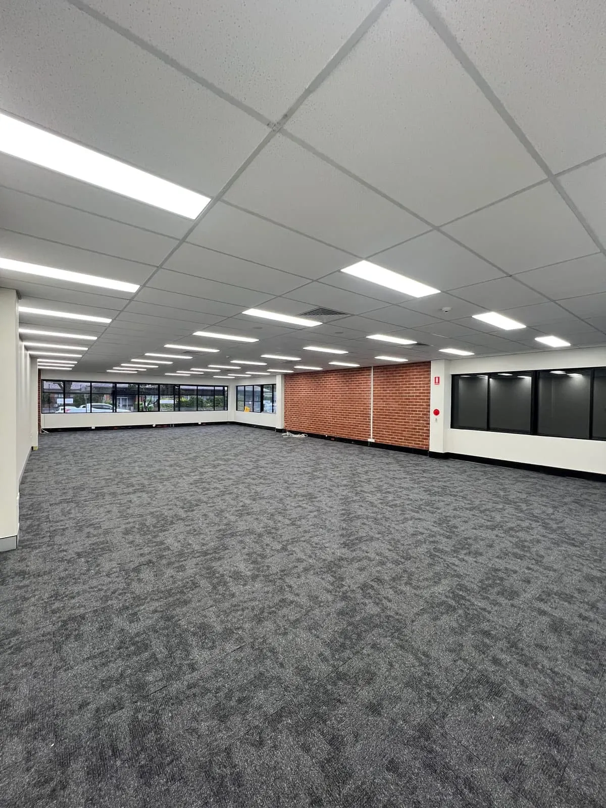 Commercial office fit-out with new carpet tiles and exposed brick on the Coffs Coast