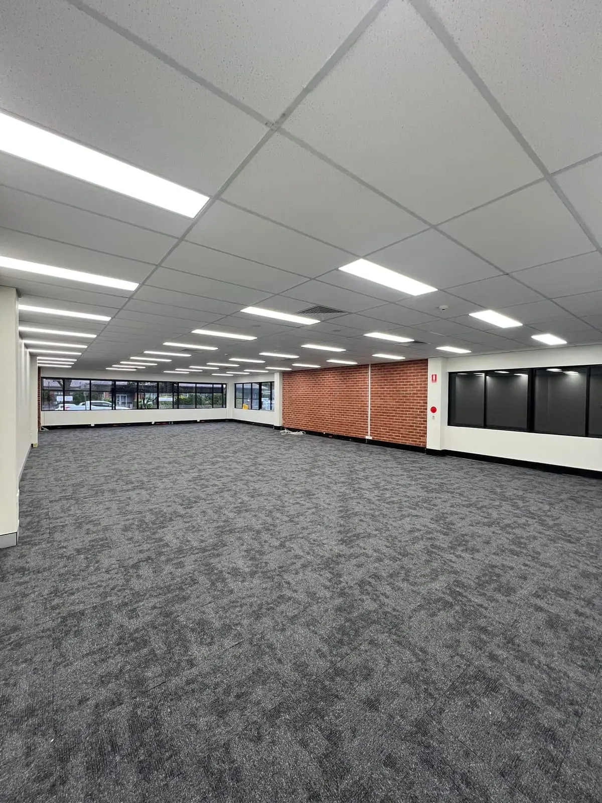 Commercial office fit-out with new carpet tiles and exposed brick on the Coffs Coast