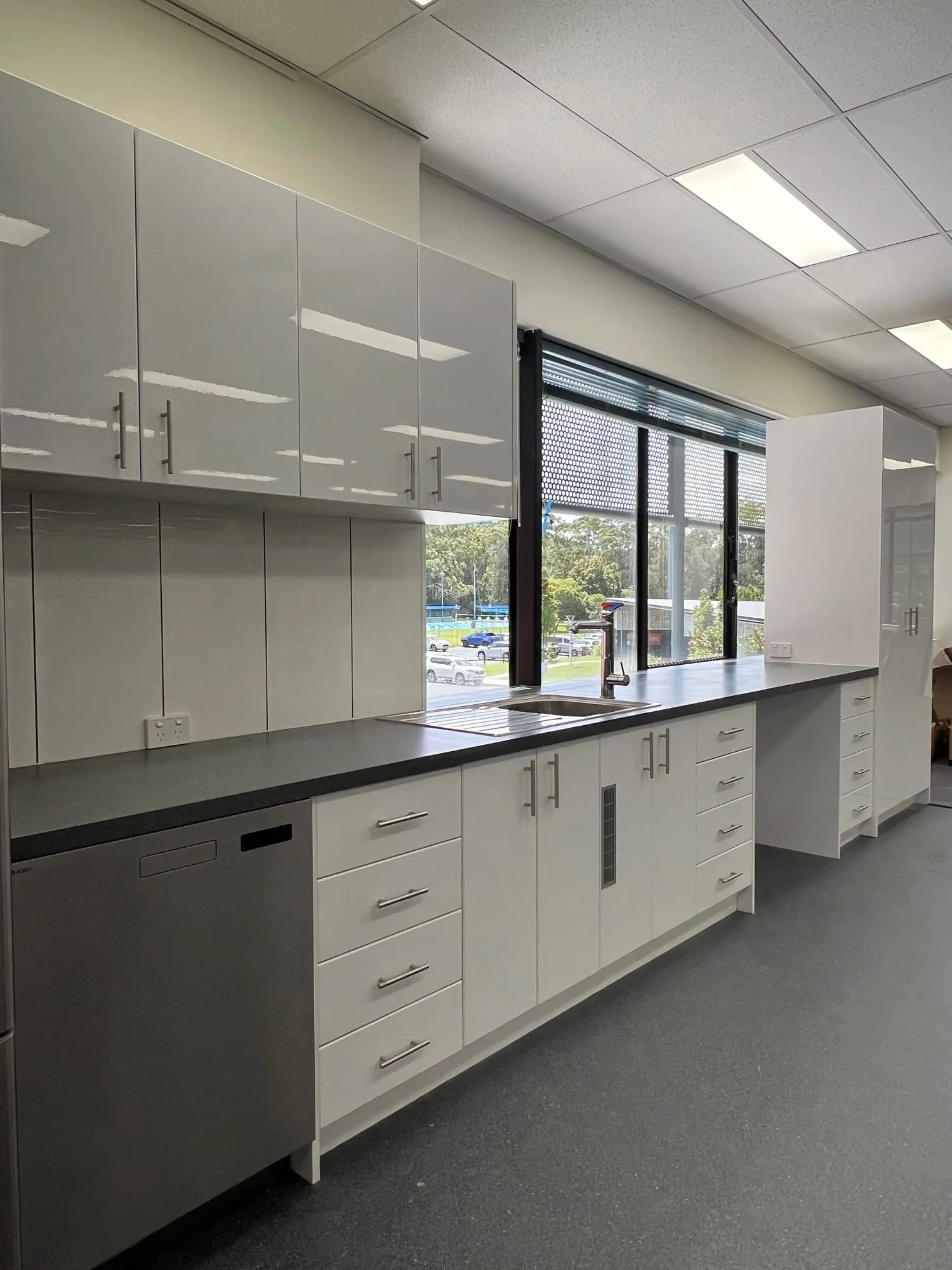 New office kitchenette with overhead cupboards and stone benchtop at Rigby House, Coffs Harbour