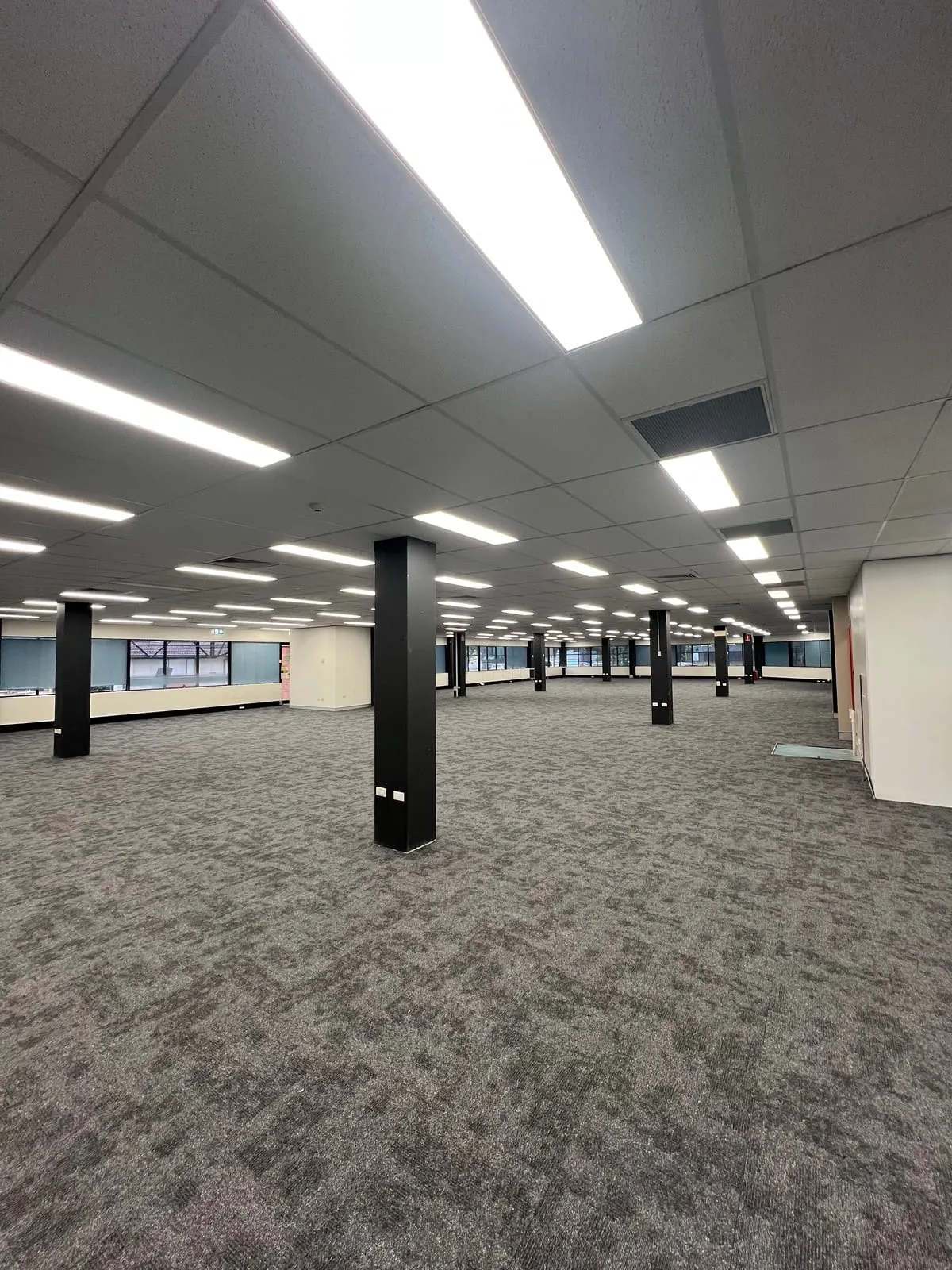 Refurbished Rigby House office floor with painted columns and new lighting, Coffs Harbour