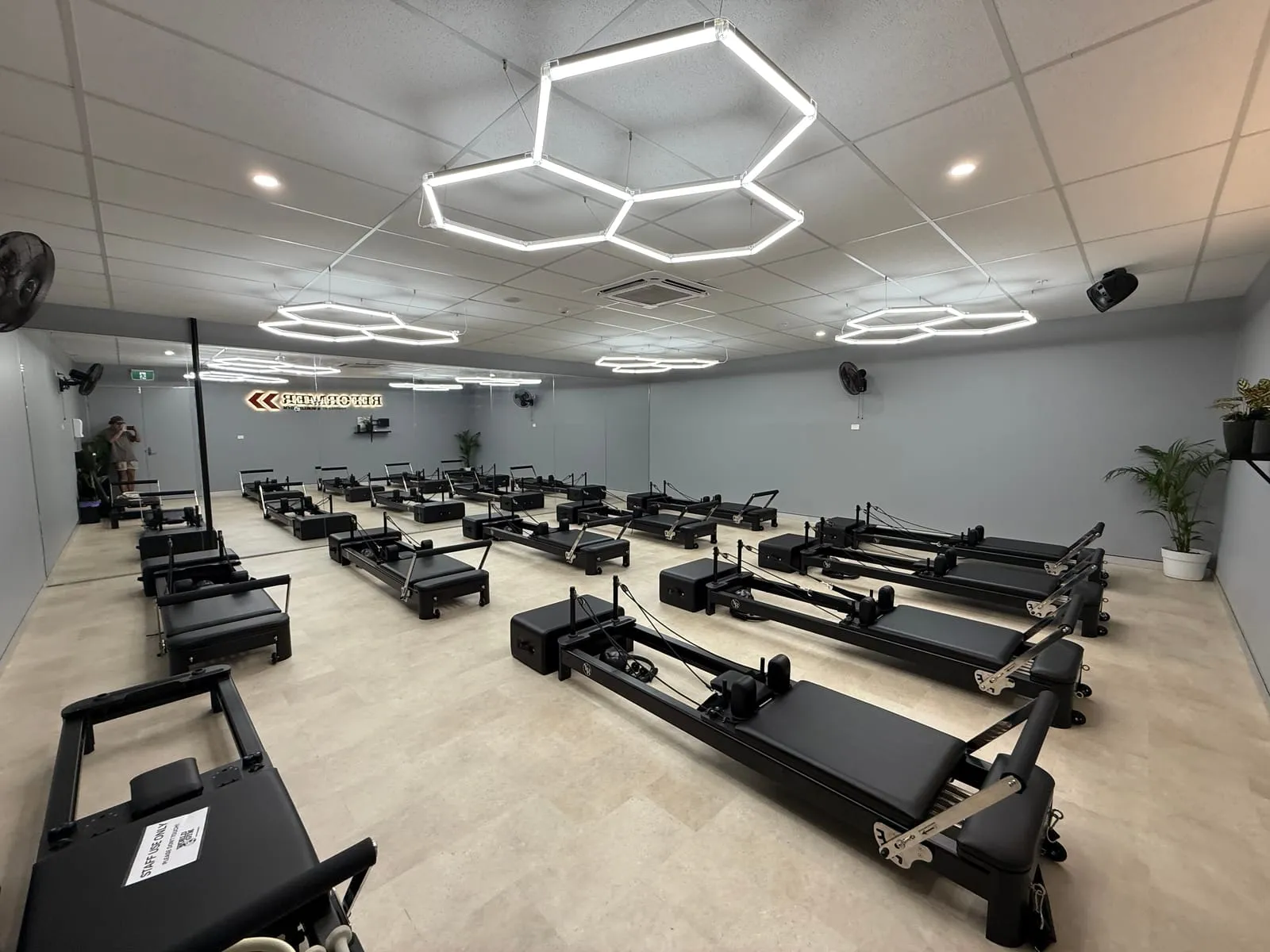 Hexagon feature lighting installed across the World Gym Coffs Harbour reformer studio ceiling